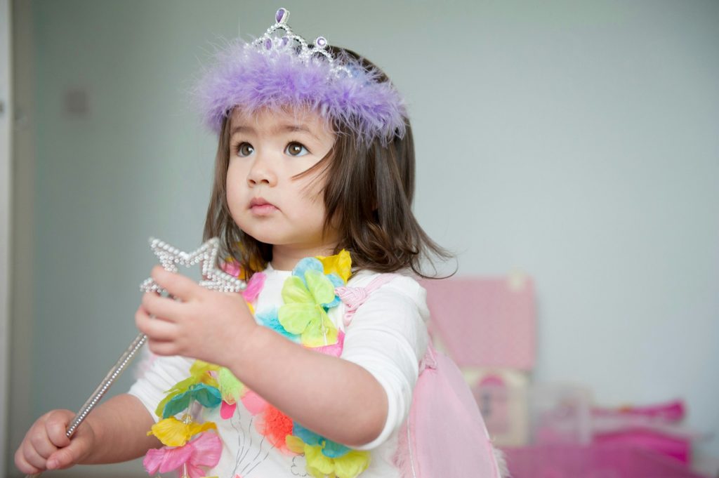 Girl in fairy costume holding magic wand